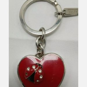 Coach branded heart locket keychain ladybug